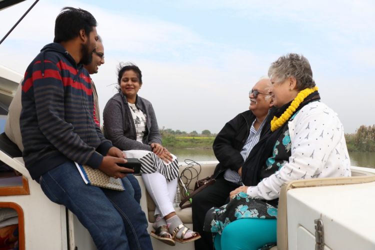 Pilgrims enjoy the refreshing breeze on the Ganga