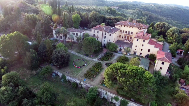 Yoga class students sit in a circle outside Villa Vrindavana, in the beautiful Tuscan countryside